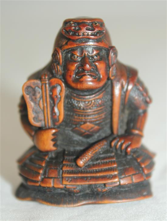 A Japanese boxwood netsuke of a seated Samurai General, late 19th century, 4.5cm